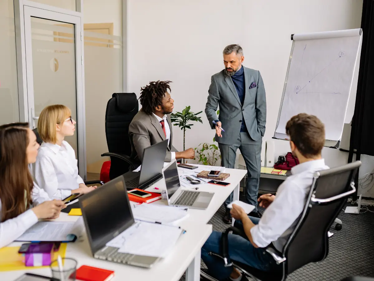 Marketing agency team reviewing performance data and refining client strategy